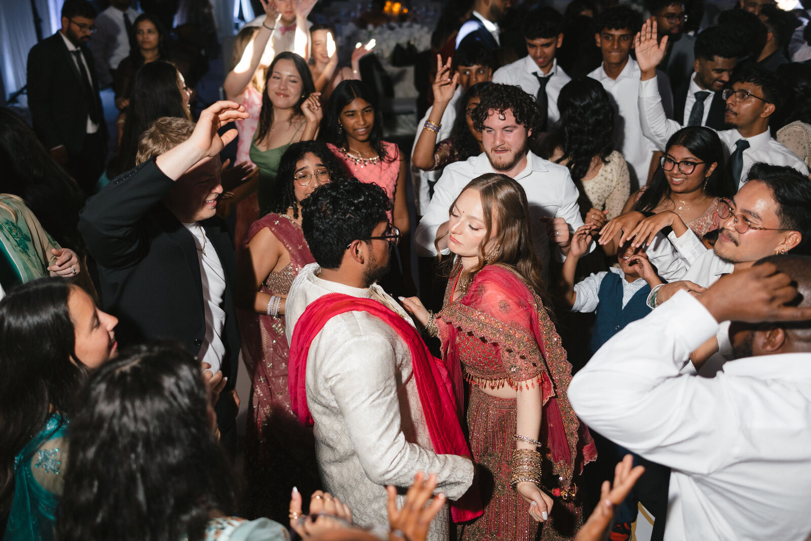 Couple dancing with guests at the reception